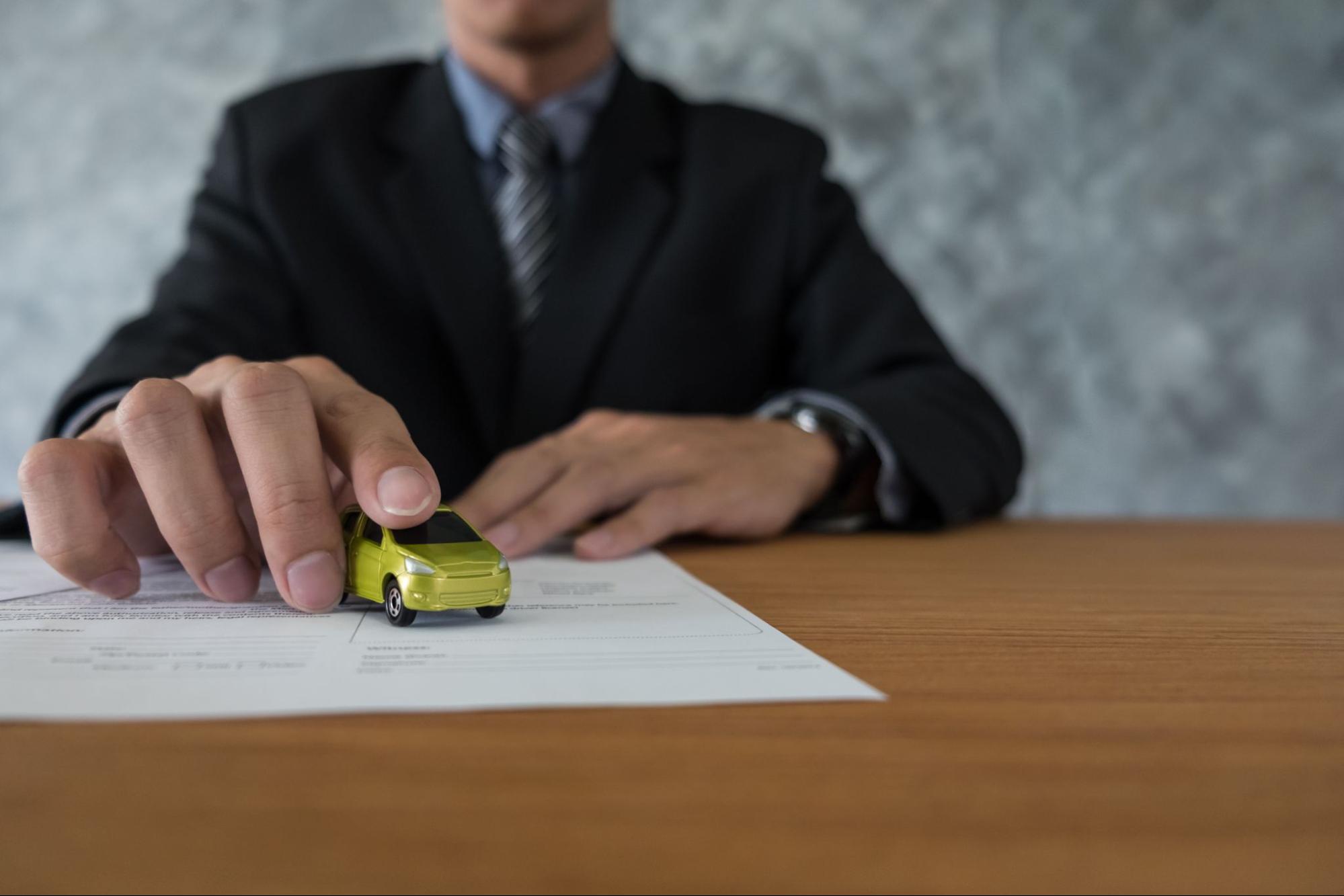 A Hand holding a toy car