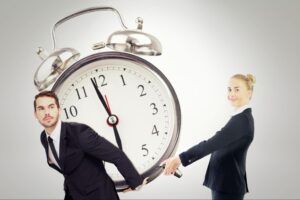 Two people carrying a clock