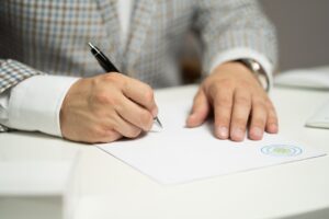 Image of a man signing documents