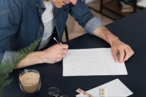 man writing a letter