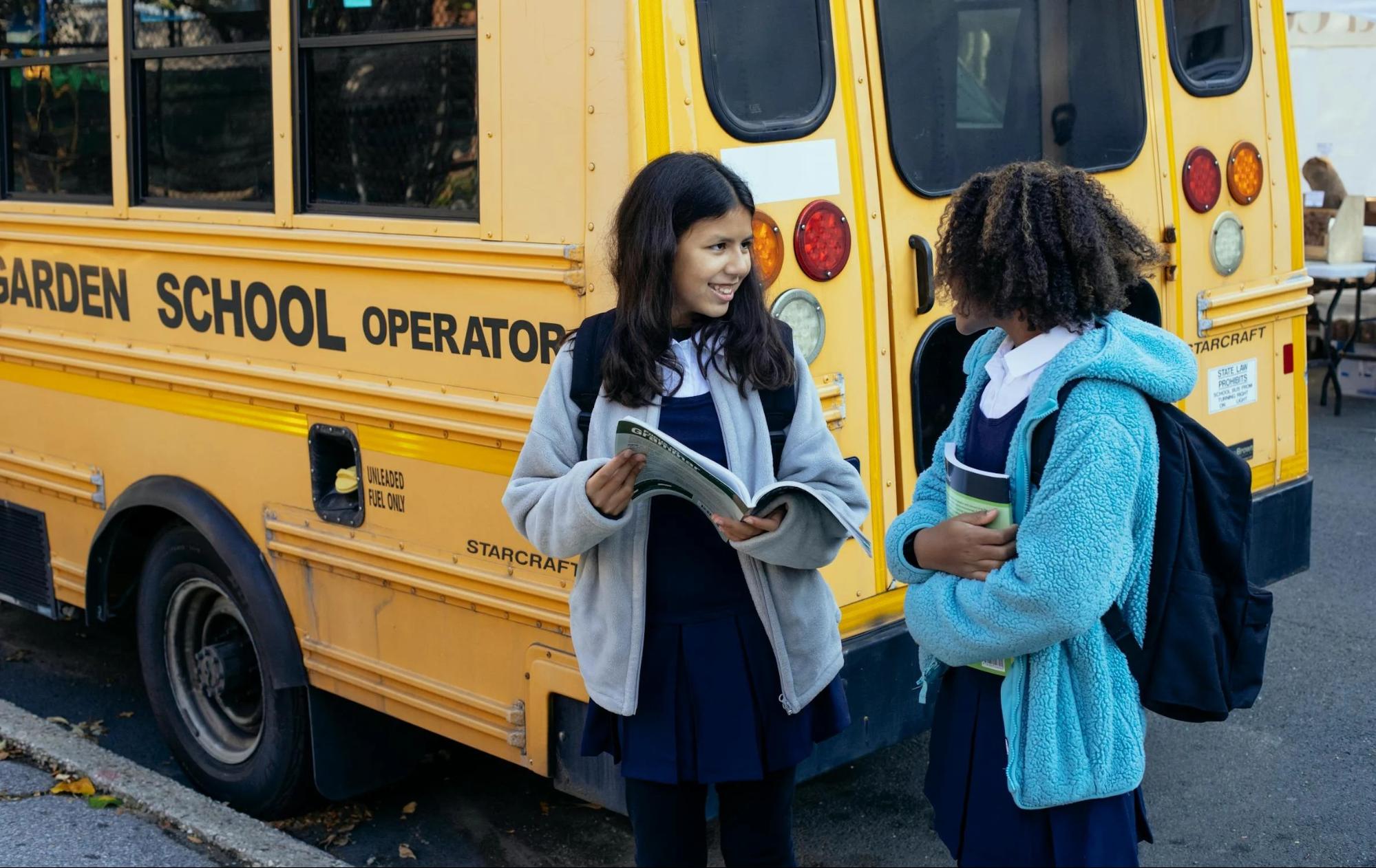 Students standing near a school bus.