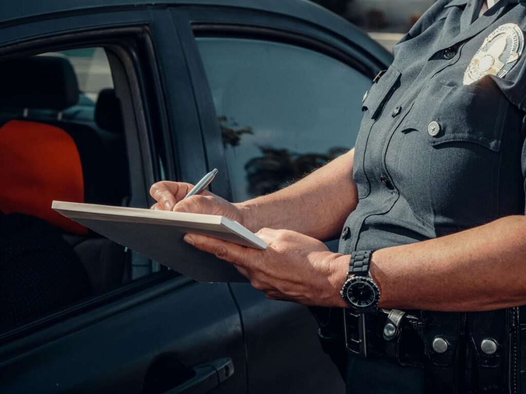 Police officer writing in notebook.