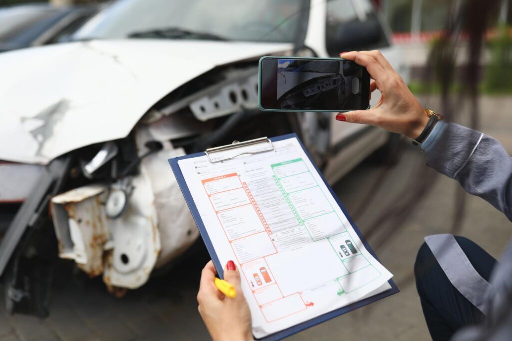 a broken car and insurance documents