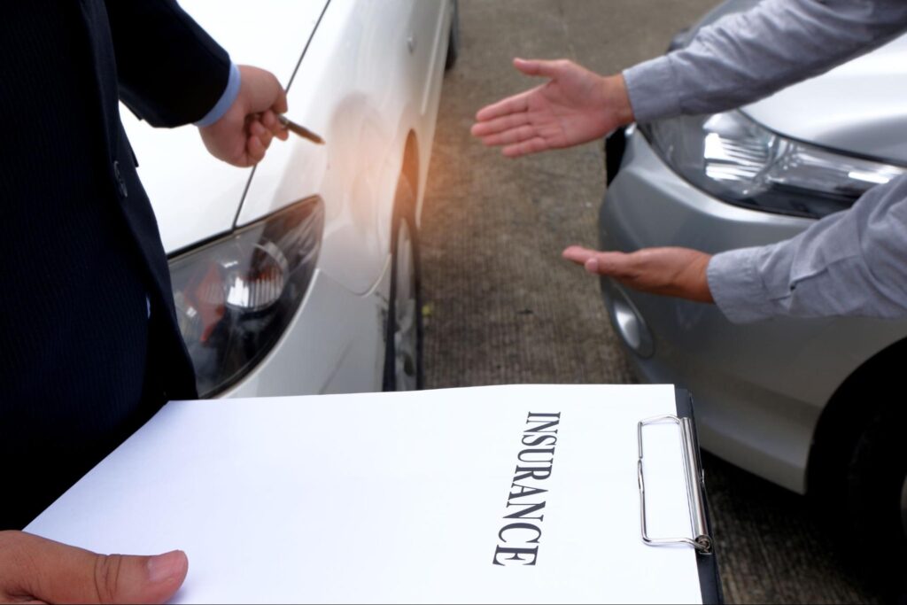 Insurance Agent Inspecting Damaged Car