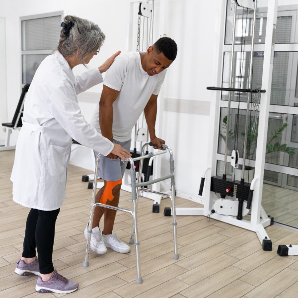 Physical therapist assisting an injured patient with exercises