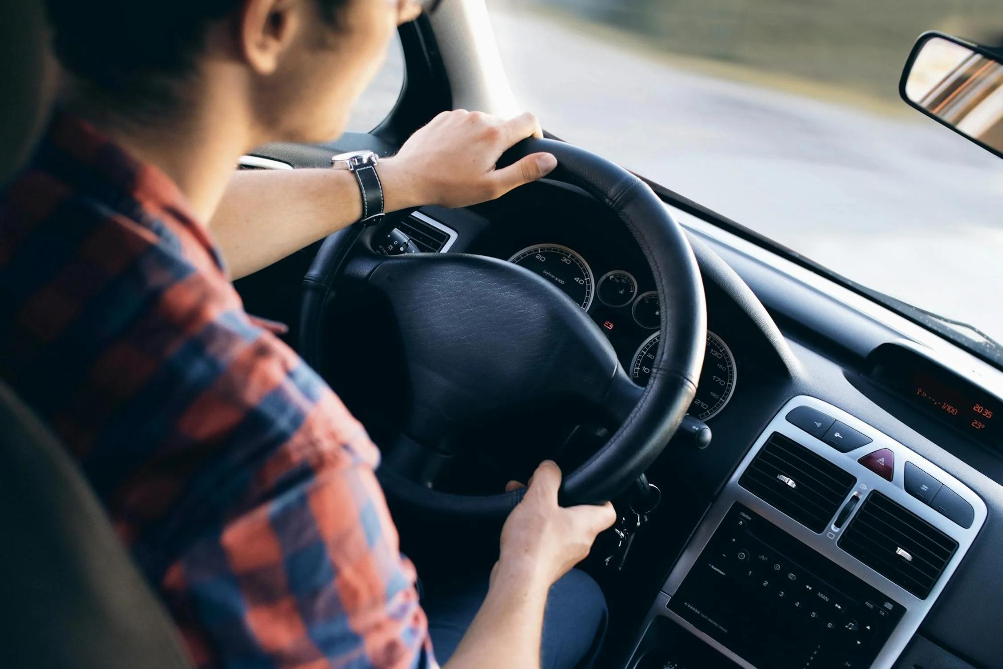 A person holding the steering wheel.