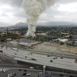 A plume of smoke and road traffic